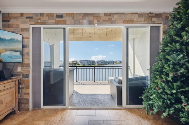 doorway to outside featuring crown molding