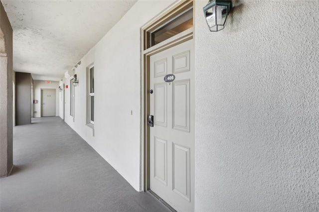 hallway with a textured ceiling