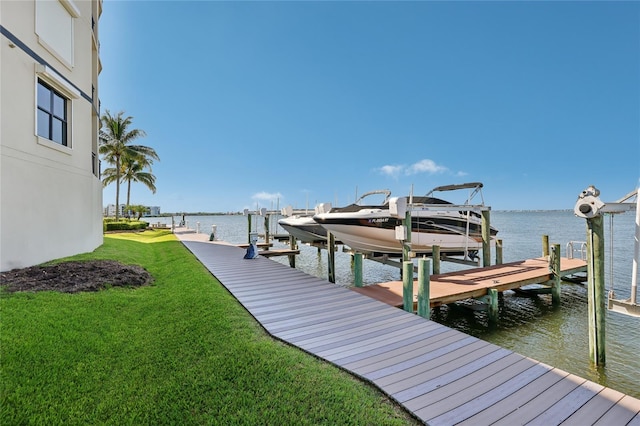 dock area featuring a water view and a yard