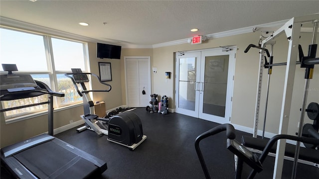 workout area with a textured ceiling, crown molding, and french doors