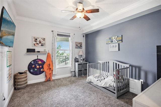 carpeted bedroom featuring ceiling fan, a crib, and ornamental molding