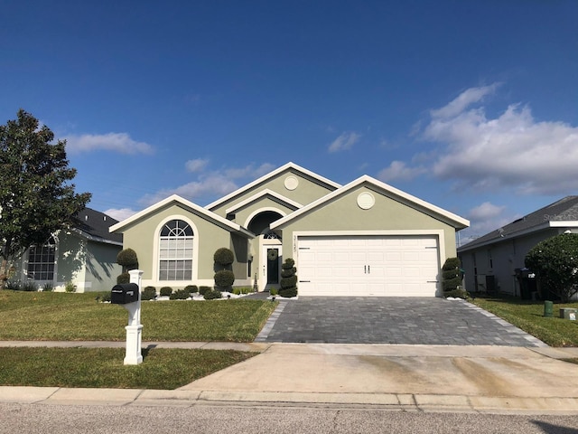 single story home featuring a garage and a front yard