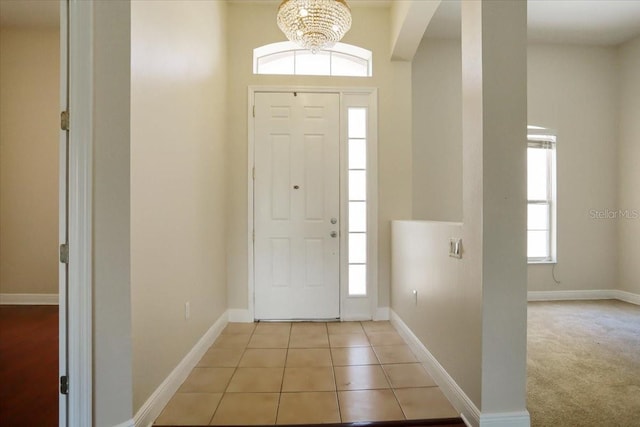 foyer with an inviting chandelier and light tile patterned floors