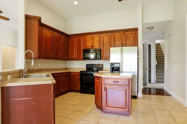 kitchen featuring black appliances, sink, light tile patterned floors, and ceiling fan