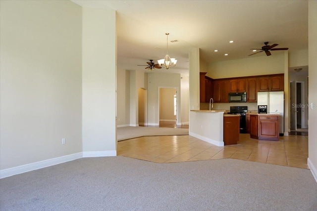 kitchen with ceiling fan with notable chandelier, pendant lighting, black appliances, sink, and light carpet