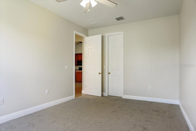 unfurnished bedroom featuring ceiling fan and carpet floors