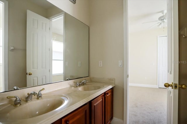 3757 Eagle Isle Cir, Kissimmee, FL 34746 - full bathroom with baseboards, double vanity, a sink, and a ceiling fan