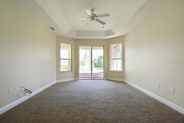 3757 Eagle Isle Cir, Kissimmee, FL 34746 - carpeted empty room with a raised ceiling, baseboards, ceiling fan, and visible vents