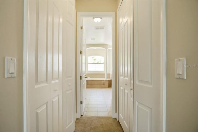 3757 Eagle Isle Cir, Kissimmee, FL 34746 - hallway with light tile patterned floors, light colored carpet, and visible vents