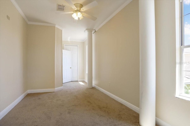 hallway featuring carpet floors, ornamental molding, and ornate columns