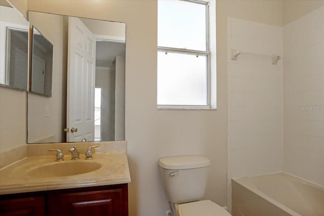 full bathroom with tiled shower / bath combo, vanity, and toilet