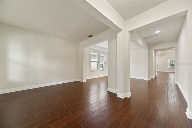 spare room with dark wood-type flooring