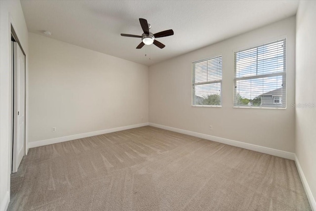 unfurnished bedroom with ceiling fan, light colored carpet, and a closet