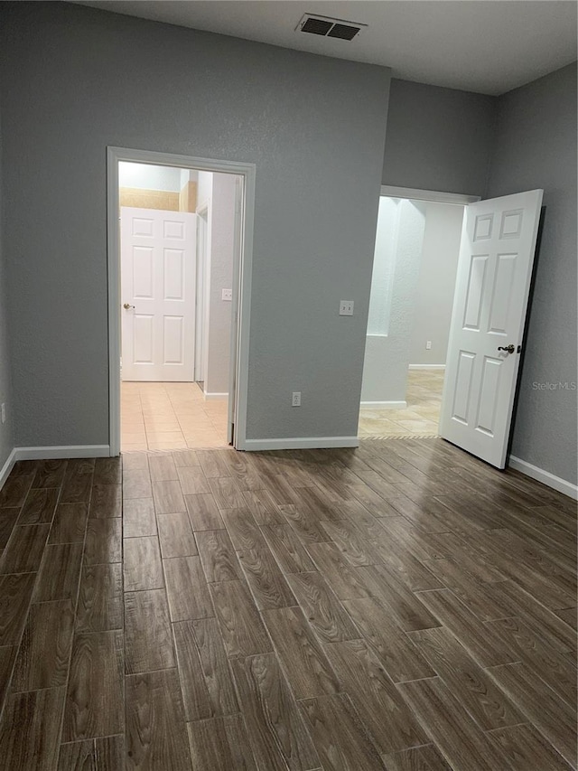 unfurnished room with dark wood-type flooring