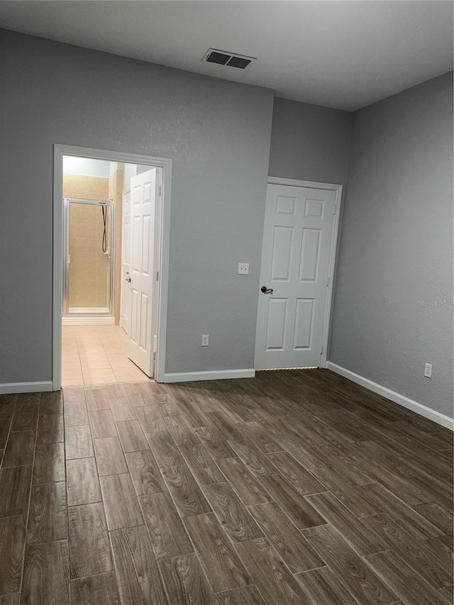 empty room with dark wood-type flooring