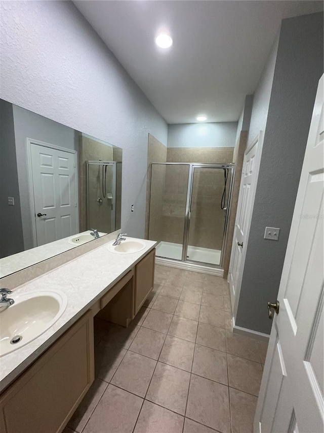 bathroom featuring walk in shower, tile patterned flooring, and vanity