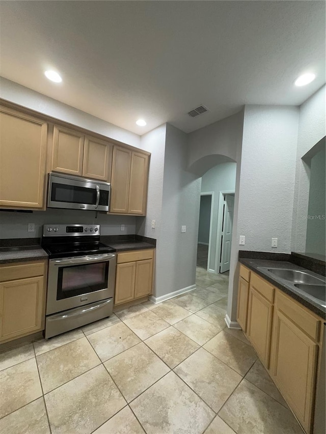 kitchen with appliances with stainless steel finishes and light tile patterned floors