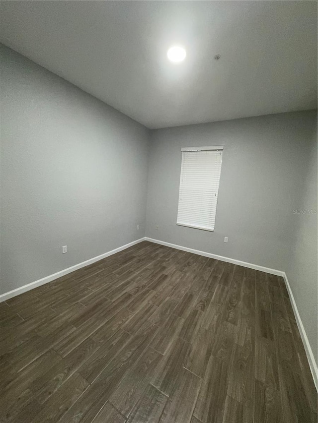 empty room with dark hardwood / wood-style floors