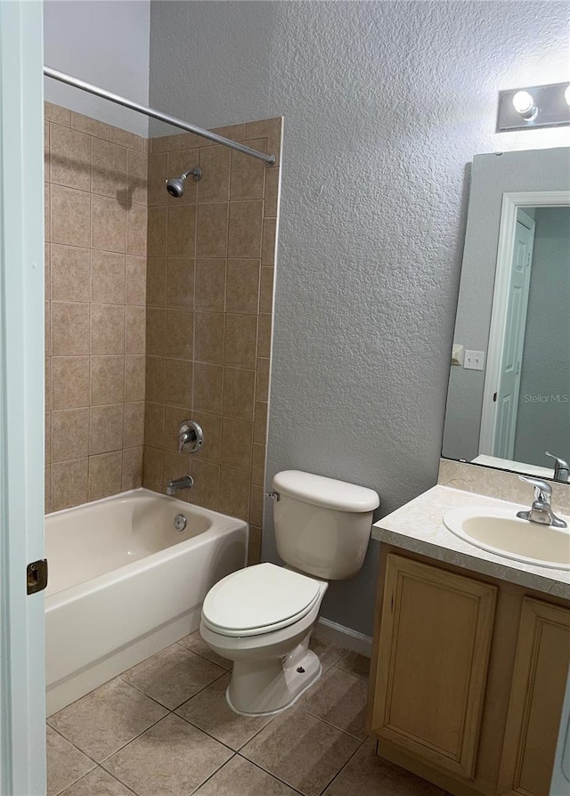 full bathroom featuring tiled shower / bath combo, tile patterned flooring, vanity, and toilet