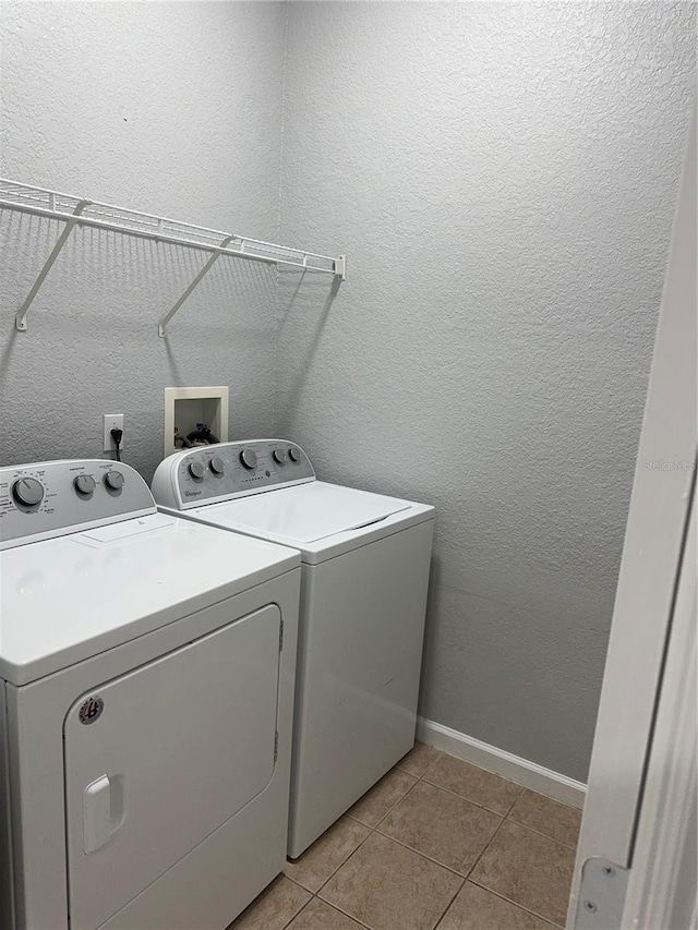 laundry room with light tile patterned flooring and washer and dryer