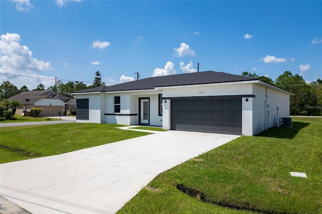 ranch-style house with central AC, a front yard, and a garage