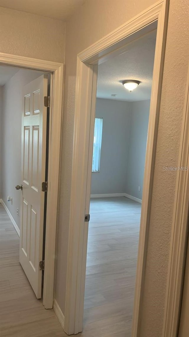 corridor featuring light hardwood / wood-style floors