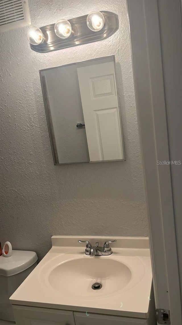 bathroom with vanity and toilet