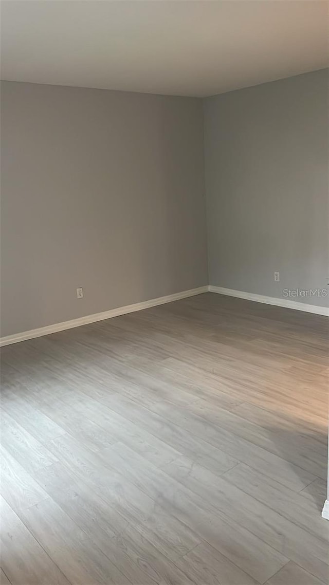 empty room with light hardwood / wood-style flooring