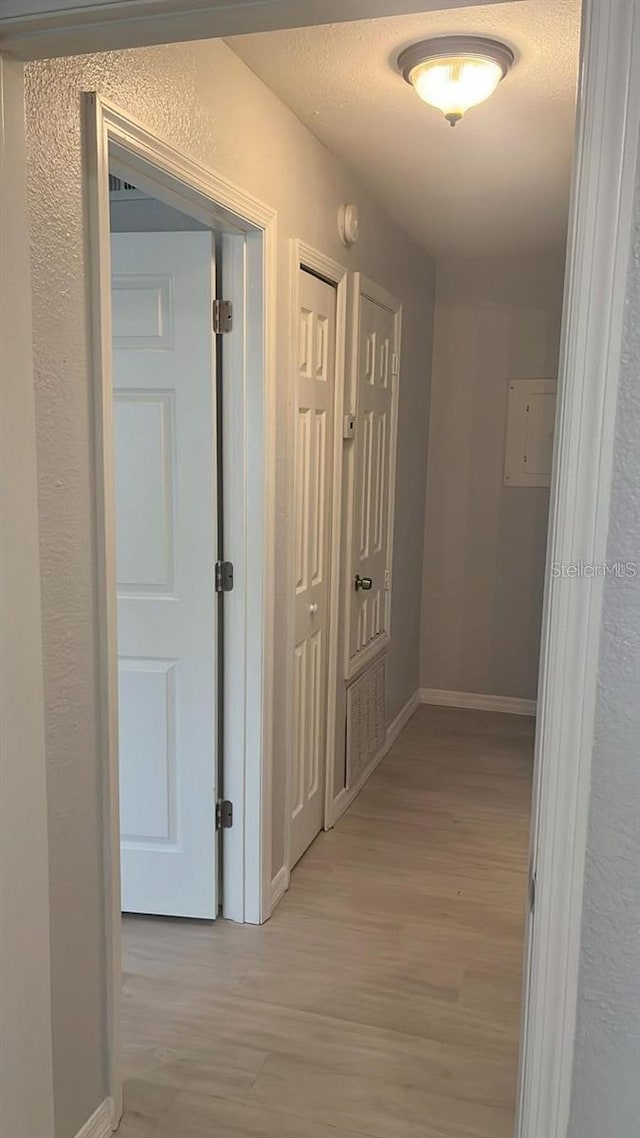 hallway with light hardwood / wood-style flooring