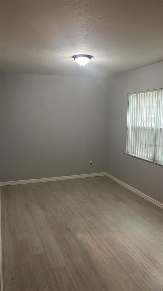 spare room featuring hardwood / wood-style floors