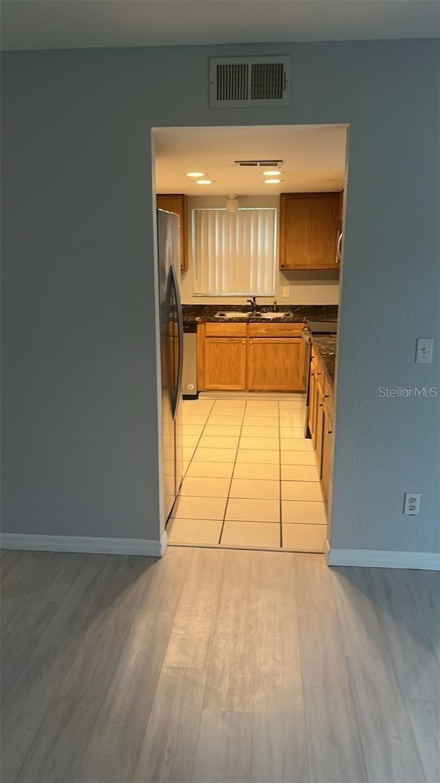 kitchen featuring light hardwood / wood-style floors, appliances with stainless steel finishes, and sink