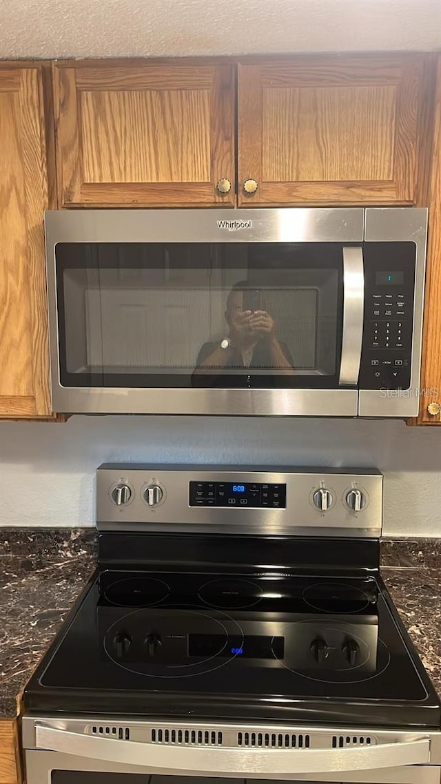 interior details with stainless steel appliances and dark stone countertops