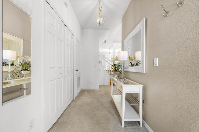 1256 S Beach Cir, Kissimmee, FL 34746 - corridor featuring baseboards, a chandelier, stairway, and carpet