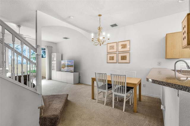 1256 S Beach Cir, Kissimmee, FL 34746 - dining area featuring light colored carpet, visible vents, arched walkways, and an inviting chandelier