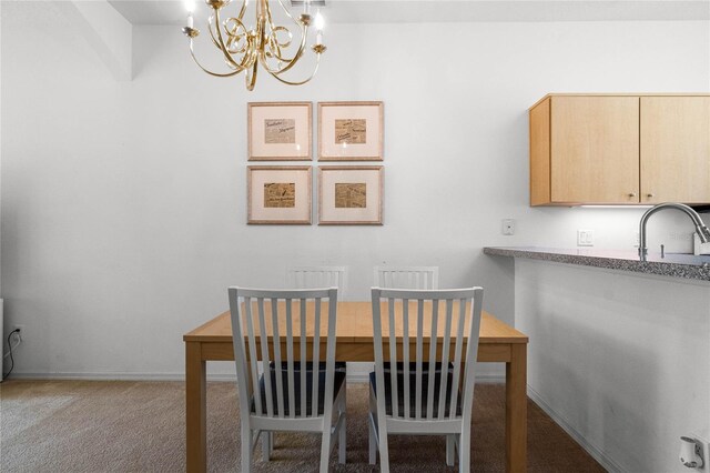 carpeted dining room featuring an inviting chandelier and sink