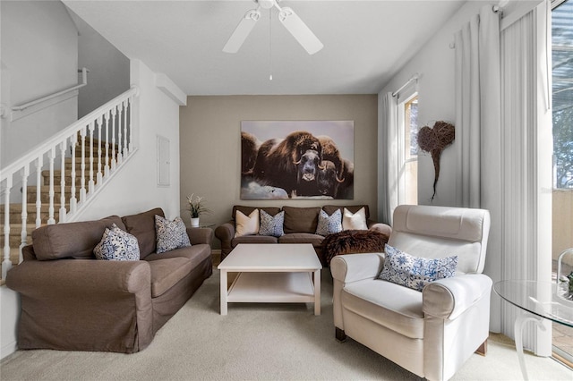 carpeted living room featuring ceiling fan