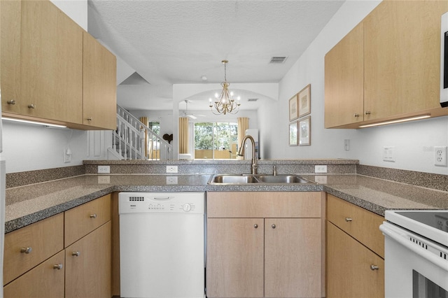 kitchen featuring a notable chandelier, white appliances, light brown cabinetry, and sink