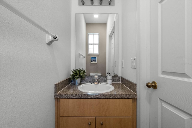 1256 S Beach Cir, Kissimmee, FL 34746 - bathroom featuring a textured wall and vanity