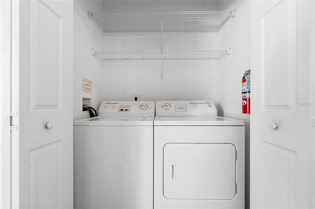 clothes washing area featuring washer and clothes dryer