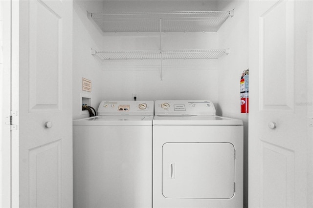 1256 S Beach Cir, Kissimmee, FL 34746 - clothes washing area with washing machine and dryer and laundry area