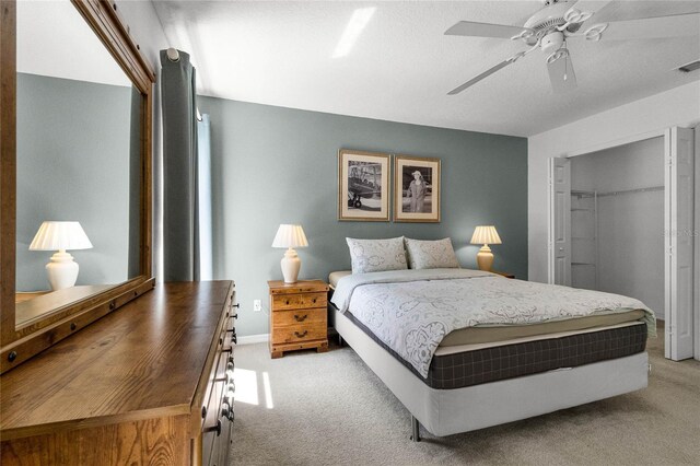 carpeted bedroom with a closet and ceiling fan