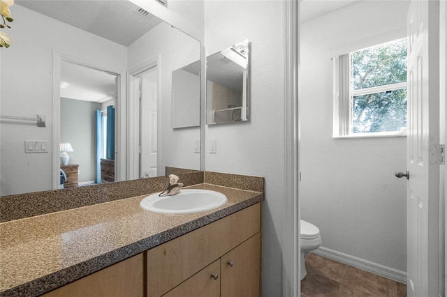 1256 S Beach Cir, Kissimmee, FL 34746 - bathroom with toilet, vanity, tile patterned floors, and baseboards