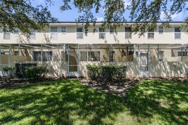 1256 S Beach Cir, Kissimmee, FL 34746 - back of house with a lawn, cooling unit, and stucco siding