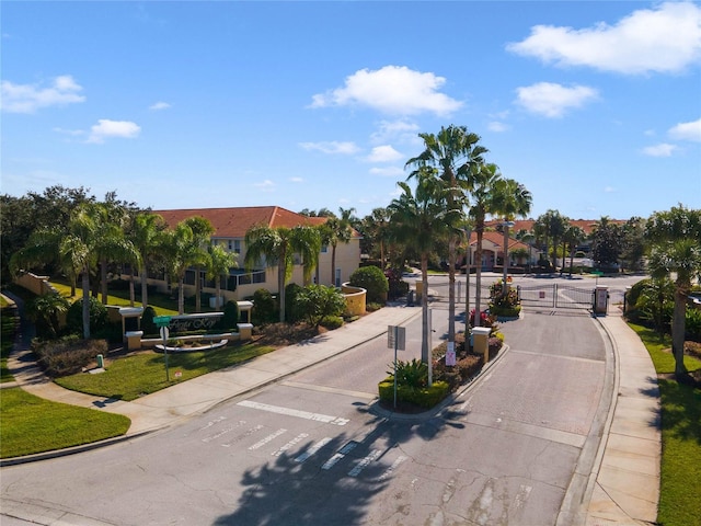 1256 S Beach Cir, Kissimmee, FL 34746 - view of street with curbs, a gated entry, and sidewalks