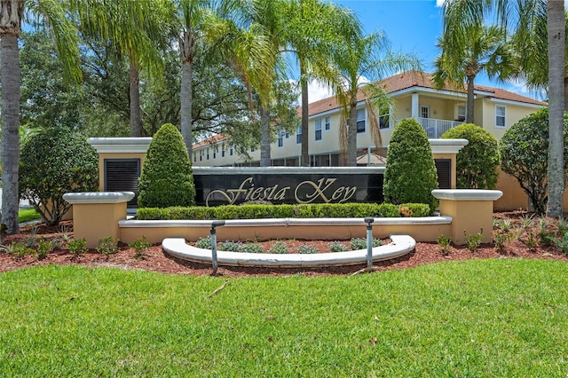 community sign featuring a lawn