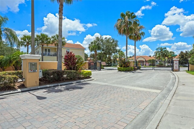 1256 S Beach Cir, Kissimmee, FL 34746 - view of street with a gate, a gated entry, and curbs