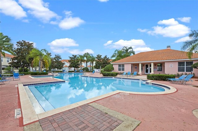 view of pool featuring a patio and a hot tub