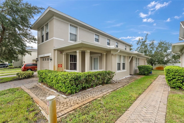 view of front of house featuring a garage and a front lawn