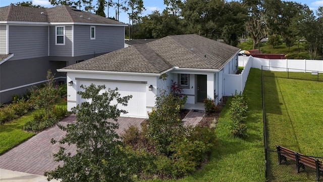 view of front of house with a front yard and a garage