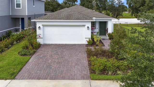 view of front of property with a garage and a front lawn